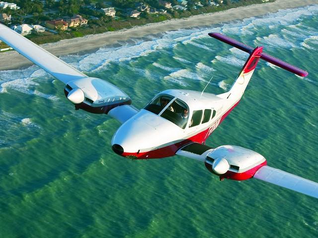 Small plane flying over the ocean